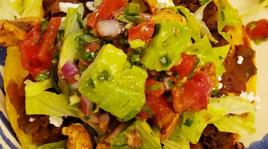 Tostadas with Spicy Chicken, Black Beans, Goat Cheese, and Avocado Enhanced Pico de Gallo
